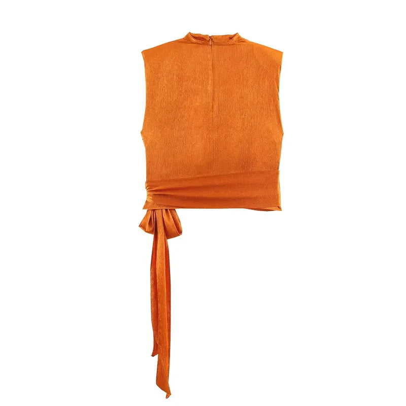 Women's top, Spring 2026 novelty: orange sleeveless design with satin texture and long tie; an elegant, stylish, and unique garment that sets the trend.