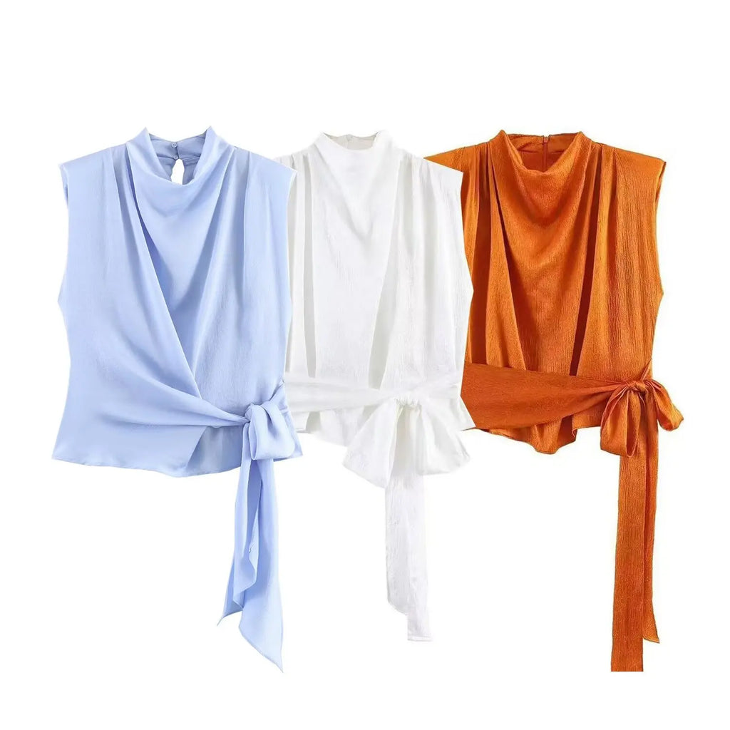Women's top, Spring 2026 novelty: orange sleeveless design with satin texture and long tie; an elegant, stylish, and unique garment that sets the trend.